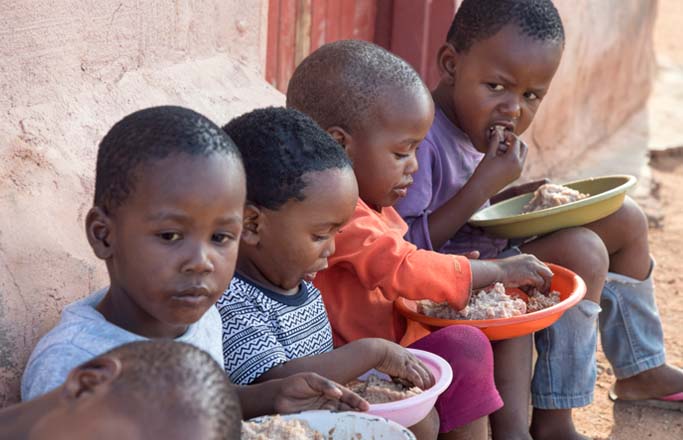 Group of african children eating